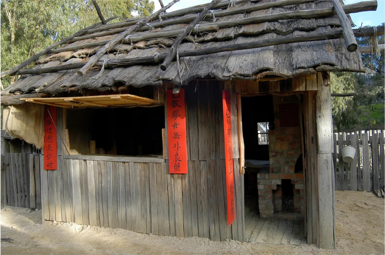 Photograph of a historical building, likely from the 19th or early 20th century, showcasing traditional construction methods.