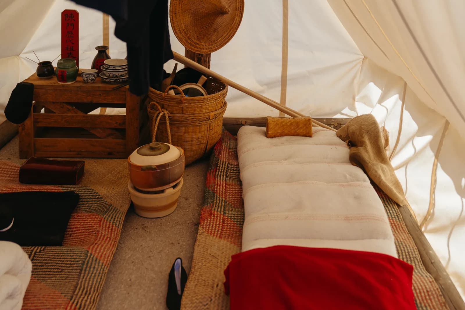 Interior of a traditional tent or dwelling, showcasing historical living arrangements and cultural artifacts.