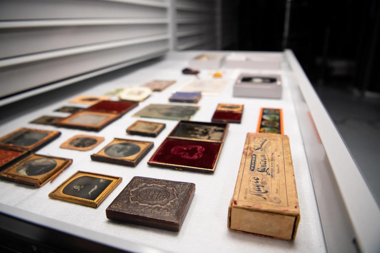 Collection of historical items at the Australian Centre for Gold Rush Collections, showcasing old photographic techniques and artifacts in a museum storage drawer.